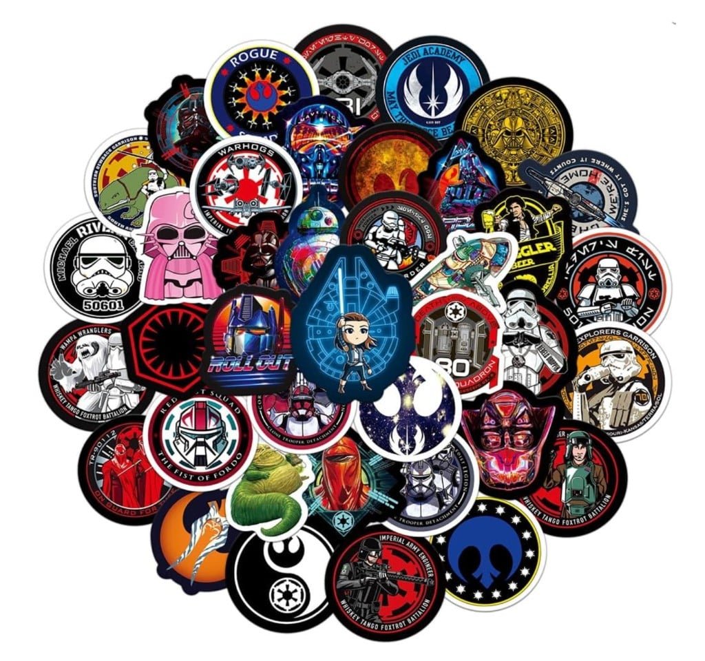 Large assortment of colorful sci-fi vinyl stickers featuring galactic character portraits, rebel and imperial emblems, and mission-patch-style decals on a white background.